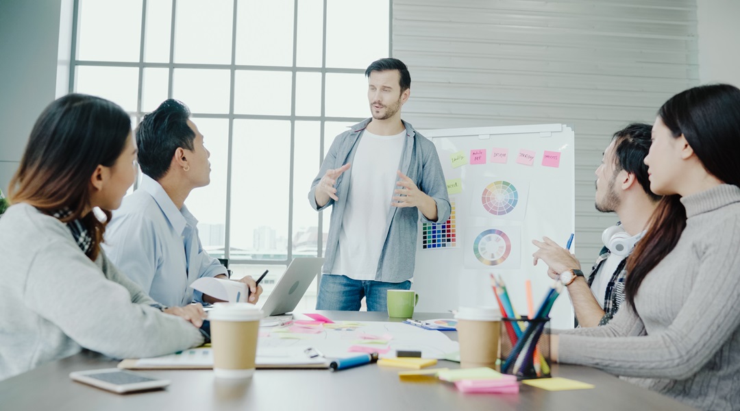 Group of casually dressed business people discussing ideas in th